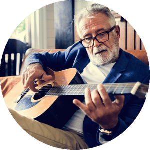 Elderly man playing guitar