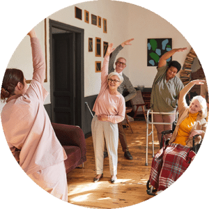 Group of elderly doing simple yoga with their aged carer